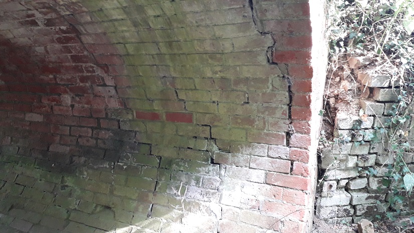visible cracks in brick arch